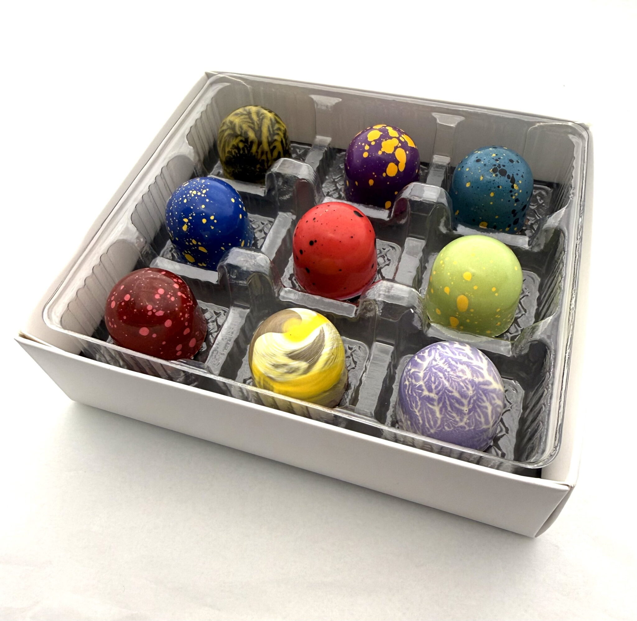 A Cacao Boys custom gift box of nine hand-painted bonbons