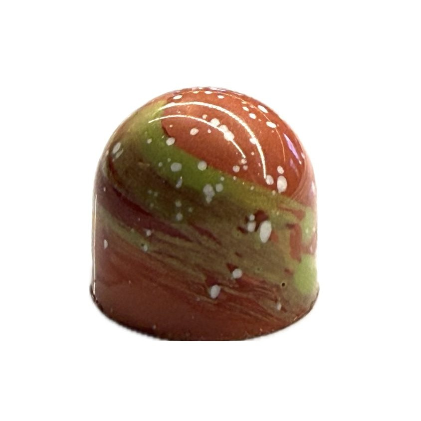 A hand-painted bonbon marbled in orange and green with white speckles