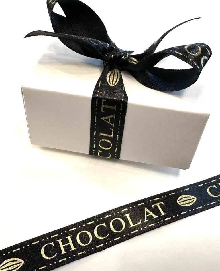 A white Cacao Boys gift box tied with a black Chocolat ribbon