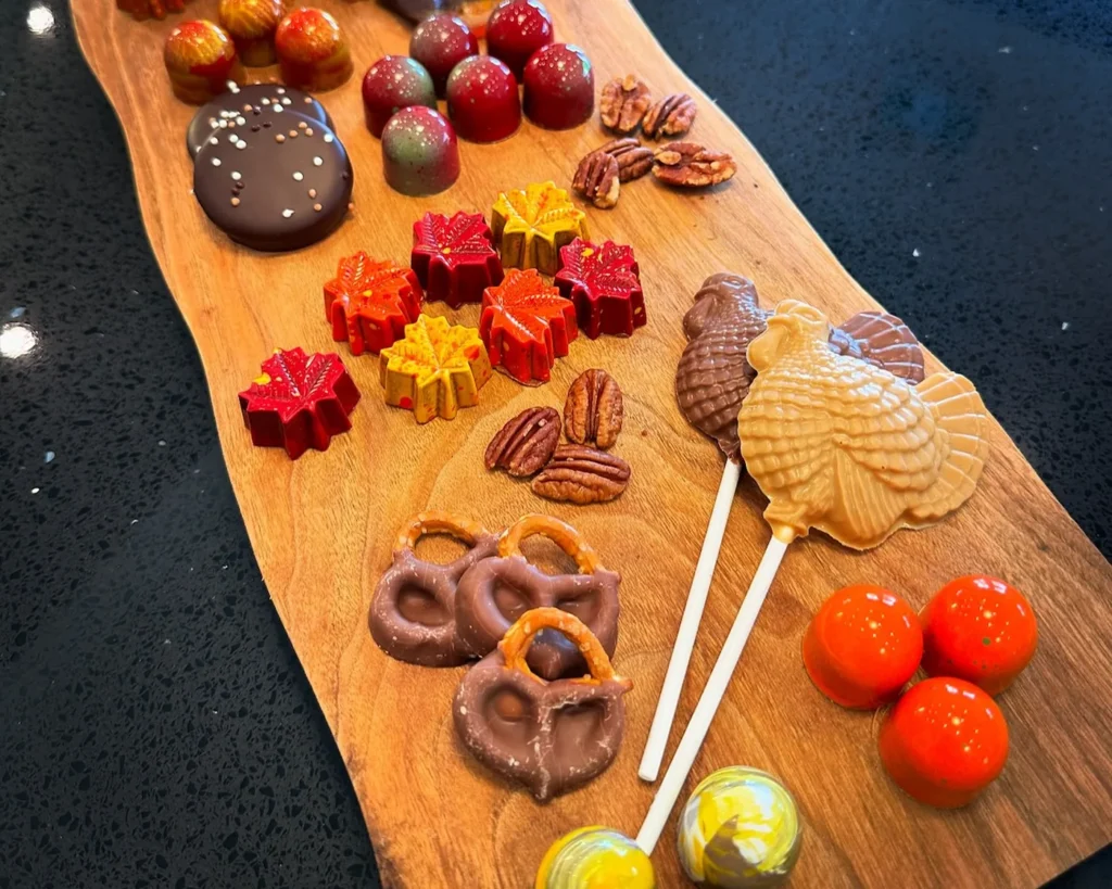 A Cacao Boys chocolate board of bonbons, clusters, and chocolate-dipped pretzels