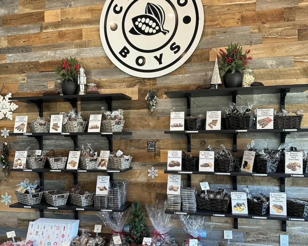 Cacao Boys products merchandised on the shop display wall beneath the Cacao Boys logo