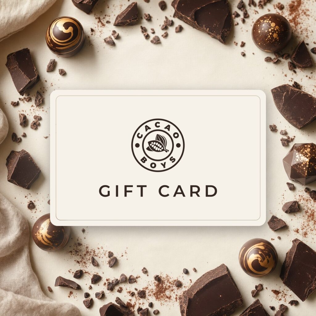 A Cacao Boys gift card on a cream linen surface, framed by hand-painted bonbons and dark chocolate pieces